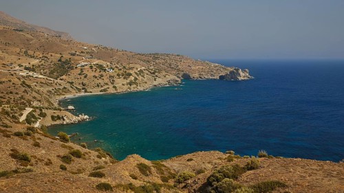 Rocky coastline overlooking calm, deep blue waters and surrounding hills, Amari Basin, Amari,