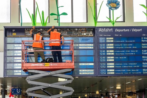 Technicians working on an electronic information board, display board for train connections at