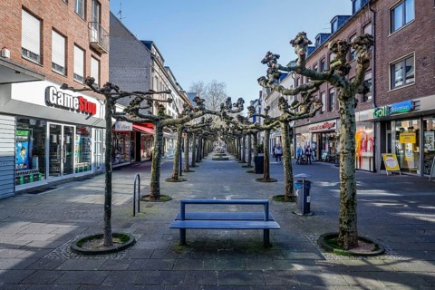 Deserted shopping street with closed shops due to corona pandemic contact ban, main street in the