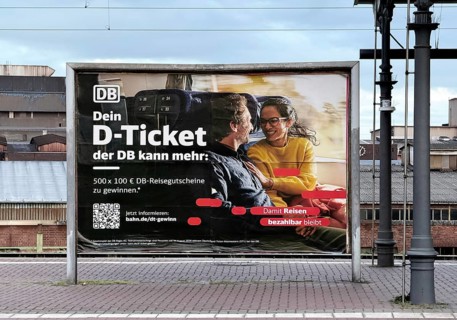 Large-format Deutsche Bahn poster for the D-ticket at the train station in Witten in front of an
