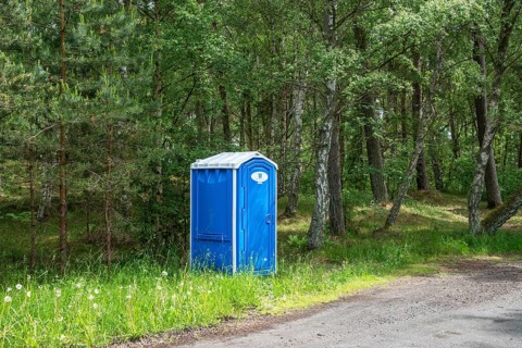 Portable toilet for the public set up at a parking lot in a forest in Ystad Municipality, Skåne