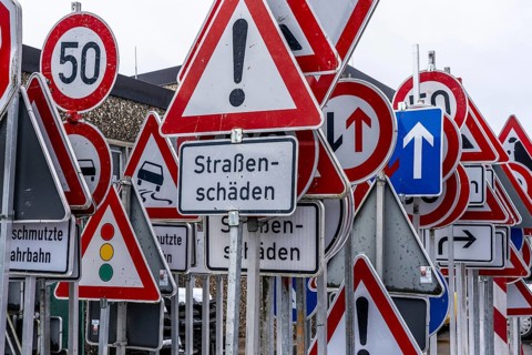 Storage for traffic signs in the yard of a road maintenance department, various signs with