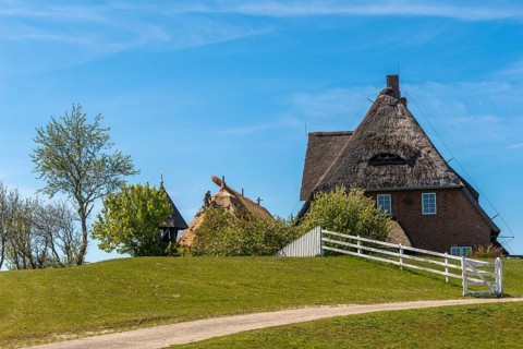 Kirchwarft with pastor and church on Hallig Hooge in the Schleswig-Holstein Wadden Sea National