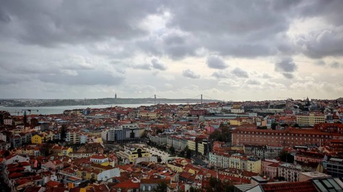 Wide view of Lisbon with river and dark clouds in the sky, Miradouro da Senhora do Monte McMlxii