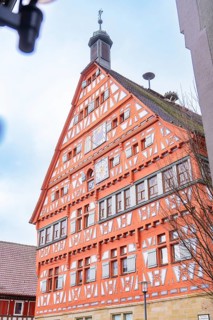 Half-timbered building with striking tower and clock, eye-catching traditional architecture, town