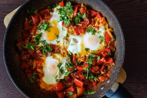 Ready-to-eat shakshouka with eggs poached in sauce of tomatoes, olive oil, peppers, onion and