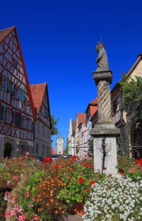 Typical Franconian village centre and the four-tube fountain in the village centre, Mainbernheim,