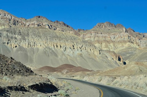 Winding road through a rocky, greenish desert landscape, Artist Drive, Death Valley National Park,
