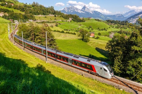 Railway passenger train of the type Stadler Flirt of the Südostbahn on the mountain Großer Mythen