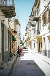 Narrow street of historic buildings thought to be Nafplio, coastal city in the Peloponnese region