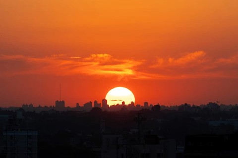 Sunset with skyline of a big city, symbol of heat, climate change and global warming, Buenos Aires,