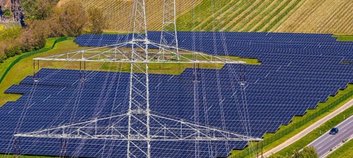 Open-space photovoltaic system, solar park in Talheim am Neckar. high voltage line. aerial view.
