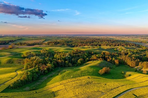 Spring landscape with blooming rapeseed fields in the Uckermark in the evening light. aerial view.