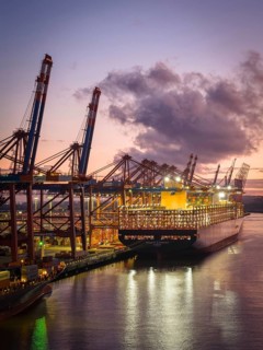 Aerial view at Waltershof harbour during the Blue Hour at the berths of Eurogate Container Terminal