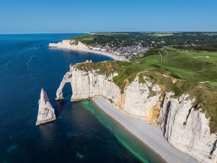 Aerial view of the Porte d'Aval rock gate with the free-standing Aiguille d'Étretat rock pin,