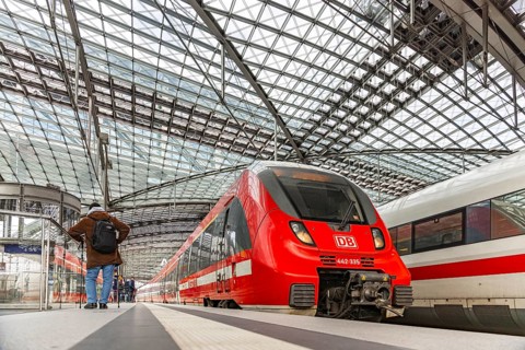 Berlin main station with regional train and ICE. Travelers on the platform. Berlin, Germany