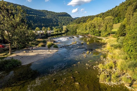 Camping site Moulin du Doubs and weir at the river Doubs near Ocourt seen from the air, Switzerland