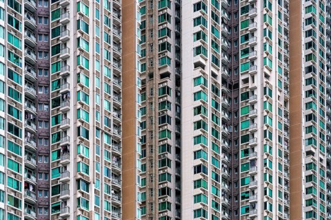 Close-up view of numerous high-rise residential towers densely packed in Hong Kong, showcasing the