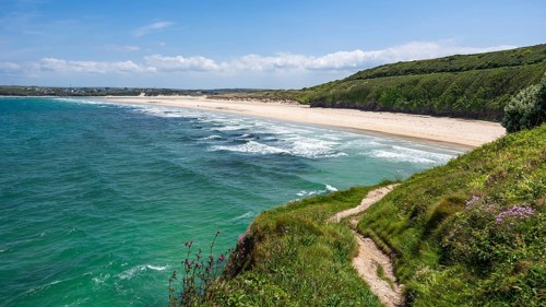 View of Porthkidney Beach. A footpath in the foreground. sandy beach beach, sea, landscape. Good