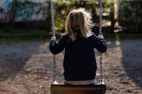 Girl, 4 years, blonde, swinging on swing, from behind, public playground, urban, Stuttgart,