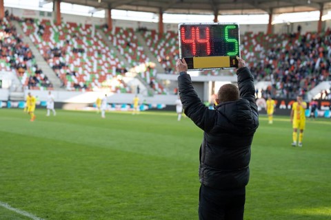 Team manager man shows players substitution during football match in Poland