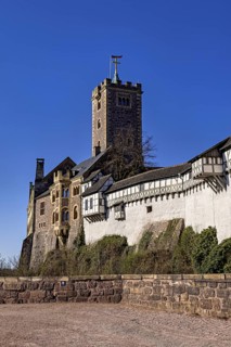 Historic castle with stone walls and banner, Wartburg Castle near Eisenach in Thuringia