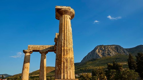 Archaic Temple of Apollo, Doric columns, Ancient columns in front of a mountain and blue sky,