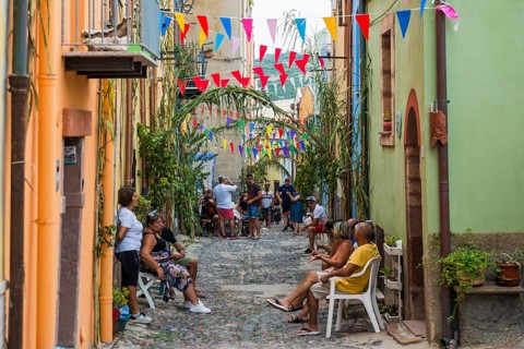 Children playing and colourful houses, Bosa, district of Oristano, Sardinia, Italy