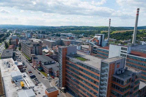 Industrial area with high chimneys and factory buildings surrounded by an urban landscape, view