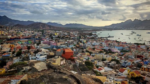 Panoramic view of Mindelo with mountains and sea and colorful houses in cloudy evening, Mindelo,