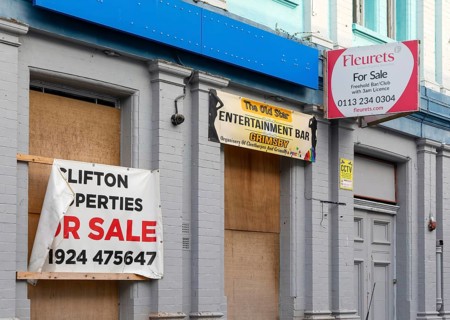 Fleurets pub estate agency For Sale sign on boarded up bar premises, Grimsby, north east