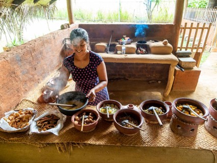 Sinhala woman prepares lunch in clay pots, Sri Lanka