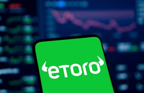 etoro logo is displayed on smartphone. eToro is a social trading and multi-asset investment company