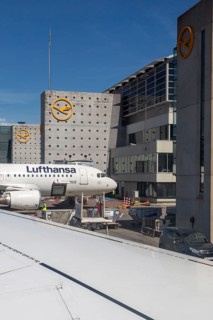 Lufthansa Airbus at the terminal, emphasised by modern architecture and clear sky at Frankfurt