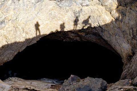 Shadow of cave rescuers on the rock above the cave entrance of the Schellenberg Ice Cave,
