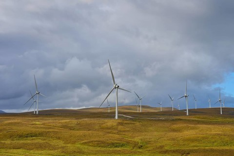 Wind turbines on green hills under a cloudy sky, Lairg, Scotland, United Kingdom, United Kingdom