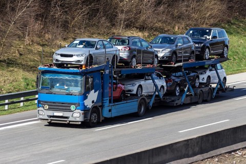 A lorry transports several new cars, car transporter on the A1 motorway, Federal Republic of