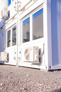 Close-up of a white container with air conditioning and windows, refugee accommodation Beermiß,