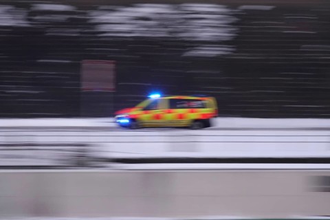 Ambulance on a road, winter, Germany