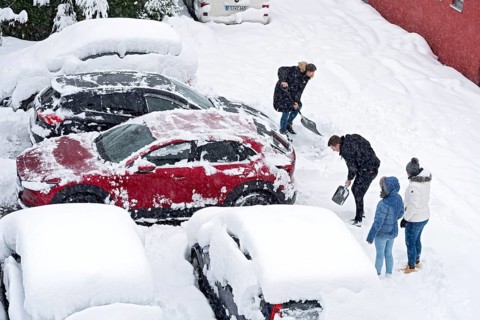 Man and woman shovelling snow on car park, car, car, snowed in, fresh snow, heavy snowfall, snow