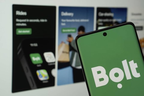 Bolt logo is displayed on a smartphone screen, with the bolt website visible on a computer screen