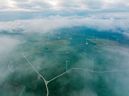 Windmills on a wind farm near Zahara de los Atunes, at a cloudy morning, aerial view, drone shot,