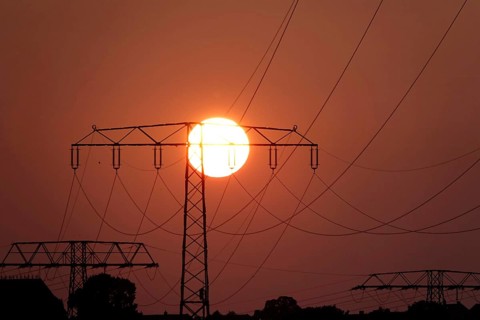 Transmission of energy with high-voltage lines, symbolic image for the energy transition, evening