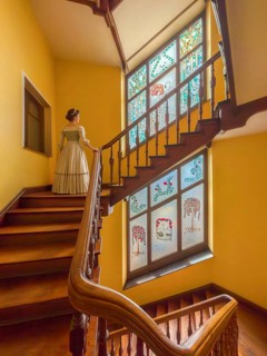 Woman wearing historical clothing in the Art Nouveau stairwell Woman built in