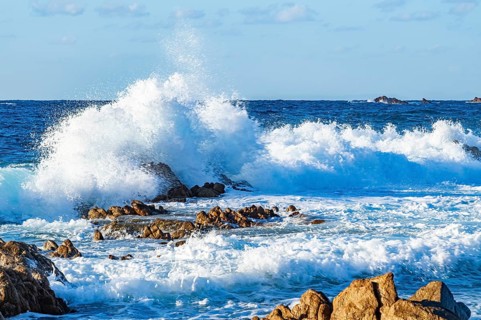 Braking waves at the coastline of Marinedda Coast at sunset, Sardinia, Italy