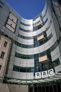 Entrance area of the BBC Broadcasting House with the distinctive curved glass façade and the BBC