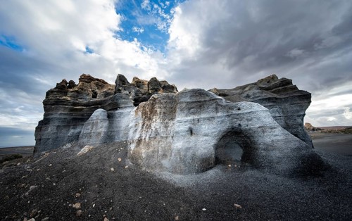 Eroded rock formations, volcanic landscape with dramatic cloudy skies, Ciudad Estratificada or Los