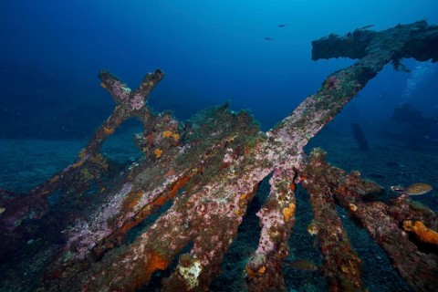 Parts of a rusted shipwreck lie on the seabed in clear water, dive site Wreck Michel C, Hyères,