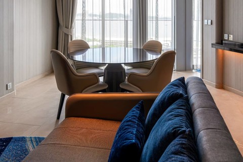 Hotel suite living area with sofa and dining table, Pattaya, Thailand