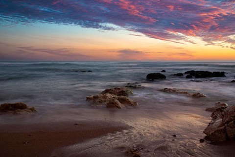 Sunset over the sea with rock formations and colorful sky, sunset, Praia do Amado, Carrapateira,